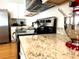 Kitchen featuring granite countertops, stainless steel appliances, and white cabinets at 2630 Angel Falls Dr, Davenport, FL 33837