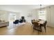 Bright living and dining area with wood floors, stylish furniture, and sliding doors to the backyard at 2630 Angel Falls Dr, Davenport, FL 33837