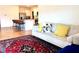 Comfortable living room with a decorative rug, neutral-toned sofa, and an open view into the kitchen at 2630 Angel Falls Dr, Davenport, FL 33837