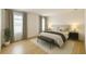 Lovely bedroom with wood-style floors, two windows and neutral colored decor at 2630 Angel Falls Dr, Davenport, FL 33837