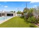 Expansive backyard featuring a well-manicured lawn, vibrant landscaping, and a sparkling pool, perfect for outdoor living at 3010 Bay Tree Dr, Orlando, FL 32806