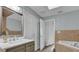 Bathroom featuring modern vanity, soaking tub, and view to commode at 3010 Bay Tree Dr, Orlando, FL 32806