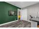 Well-lit bedroom with green accent wall, gray flooring and a walk-in closet at 3010 Bay Tree Dr, Orlando, FL 32806
