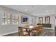 Sunlit dining room with modern decor, wood floors, bright lighting, and an open view to the updated kitchen at 3010 Bay Tree Dr, Orlando, FL 32806