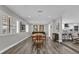 Elegant dining room with modern decor, wood floors, bright lighting, and an open view to the updated kitchen at 3010 Bay Tree Dr, Orlando, FL 32806