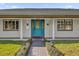 Inviting front entrance with a teal door and brick walkway at 3010 Bay Tree Dr, Orlando, FL 32806