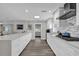 Bright kitchen features white cabinets, a spacious island, stainless steel appliances, and stylish tile backsplash at 3010 Bay Tree Dr, Orlando, FL 32806