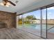 Living room featuring brick fireplace and sliding glass doors overlooking the pool and backyard at 3010 Bay Tree Dr, Orlando, FL 32806