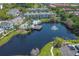 Aerial view of community with lake, pool, and colorful buildings at 3013 Bonfire Beach Dr # 101, Kissimmee, FL 34746