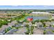 Aerial view of a neighborhood with colorful homes near a scenic pond at 3013 Bonfire Beach Dr # 101, Kissimmee, FL 34746