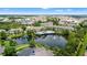 Aerial view of community, showing a community pool and surrounding lake at 3013 Bonfire Beach Dr # 101, Kissimmee, FL 34746