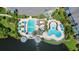 Aerial view of the community pool featuring dual pool areas, lounge seating, and surrounding greenery at 3013 Bonfire Beach Dr # 101, Kissimmee, FL 34746
