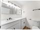 Clean bathroom featuring a double sink vanity with white countertops, black fixtures and modern lighting at 3013 Bonfire Beach Dr # 101, Kissimmee, FL 34746