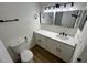 Bright bathroom featuring double mirrors, updated vanity with quartz countertops, and modern fixtures at 3013 Bonfire Beach Dr # 101, Kissimmee, FL 34746