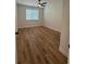 Bedroom features laminate floors, a ceiling fan, and a window providing natural light at 3013 Bonfire Beach Dr # 101, Kissimmee, FL 34746