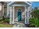 Teal front door entrance with white columns and landscaping at 3013 Bonfire Beach Dr # 101, Kissimmee, FL 34746