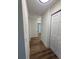 Hallway features laminate floors, white trim, and doors to various rooms, creating a seamless flow at 3013 Bonfire Beach Dr # 101, Kissimmee, FL 34746