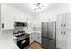 Modern kitchen with stainless steel appliances, white cabinets, and light countertops, offers both style and functionality at 3013 Bonfire Beach Dr # 101, Kissimmee, FL 34746