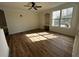 Bright living room with hardwood floors, a ceiling fan, and a large window with natural light at 3013 Bonfire Beach Dr # 101, Kissimmee, FL 34746