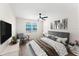 Tranquil main bedroom with neutral tones, a ceiling fan, and a view of a blue house at 3013 Bonfire Beach Dr # 101, Kissimmee, FL 34746