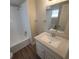 Updated bathroom with granite vanity and a shower/tub combo at 305 S Candler Ave, Orlando, FL 32835