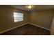 Well-lit bedroom with laminate flooring and a window with blinds at 305 S Candler Ave, Orlando, FL 32835