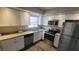 Modern kitchen with granite countertops and stainless steel appliances at 305 S Candler Ave, Orlando, FL 32835
