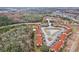 Aerial view of townhouses, pond, and surrounding landscape at 346 Monroe Cir, Davenport, FL 33896