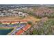 Aerial view showing townhouses, a wooded area, and neighborhood at 346 Monroe Cir, Davenport, FL 33896