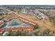 Aerial view of townhouses, a pond, and surrounding neighborhood at 346 Monroe Cir, Davenport, FL 33896