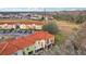 Townhome community with orange tile roofs and a large parking lot at 346 Monroe Cir, Davenport, FL 33896