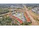 Aerial view showcasing townhouses around a pond and landscape at 346 Monroe Cir, Davenport, FL 33896