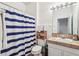 Clean bathroom with blue and white striped shower curtain at 346 Monroe Cir, Davenport, FL 33896