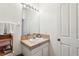 Small bathroom with single sink and light beige tile at 346 Monroe Cir, Davenport, FL 33896