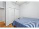 Simple bedroom with wood floors and double door closet at 346 Monroe Cir, Davenport, FL 33896