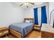 Bedroom with wood floors, blue curtains, and wood bed frame at 346 Monroe Cir, Davenport, FL 33896