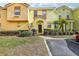 Inviting exterior of two-story townhome with landscaping and parking at 346 Monroe Cir, Davenport, FL 33896