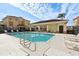 Community pool with lounge chairs and covered seating area at 346 Monroe Cir, Davenport, FL 33896