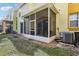 Screened in patio with small yard and AC unit at 346 Monroe Cir, Davenport, FL 33896