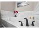 Relaxing bathroom with soaking tub, modern fixtures, and subway tile at 3720 Ryegrass St, Clermont, FL 34714