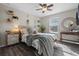 Cozy bedroom with wood-look floors and gray bedding at 3720 Ryegrass St, Clermont, FL 34714