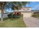 Two-story house with red accents, a brick driveway, and landscaping at 3720 Ryegrass St, Clermont, FL 34714