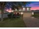 Two-story house with red accents, a brick driveway, and landscaping at 3720 Ryegrass St, Clermont, FL 34714