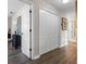 Light hallway with linen closet and wood-look floors at 3720 Ryegrass St, Clermont, FL 34714