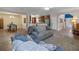 Open living room with hardwood floors and a view into the dining area at 3720 Ryegrass St, Clermont, FL 34714