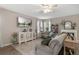 Living room with hardwood floors, neutral walls, and comfortable seating at 3720 Ryegrass St, Clermont, FL 34714