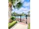 Beautiful community pool with clear blue water, framed by palm trees and a secure fence at 3720 Ryegrass St, Clermont, FL 34714