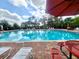 Inviting community pool with ample lounge chairs, tables, and a clear view of the sky at 3720 Ryegrass St, Clermont, FL 34714