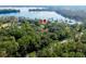 House nestled on a lakefront lot with lush trees at 4135 Chuluota Rd, Orlando, FL 32820