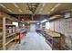 Unfinished basement space features exposed brick walls, shelving units, and work benches at 4135 Chuluota Rd, Orlando, FL 32820